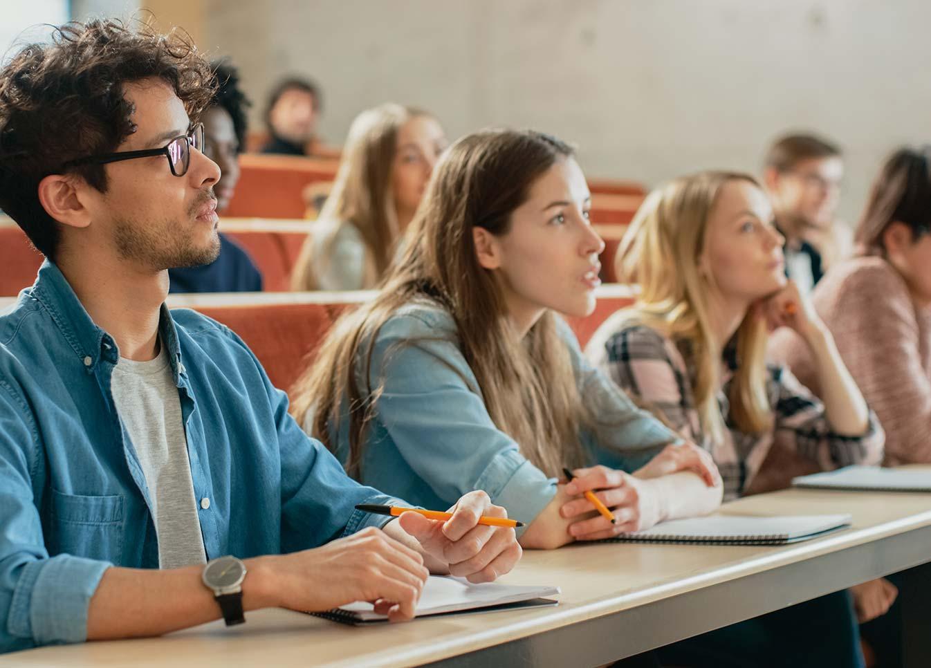 University students attentively listening to a lecture in a classroom